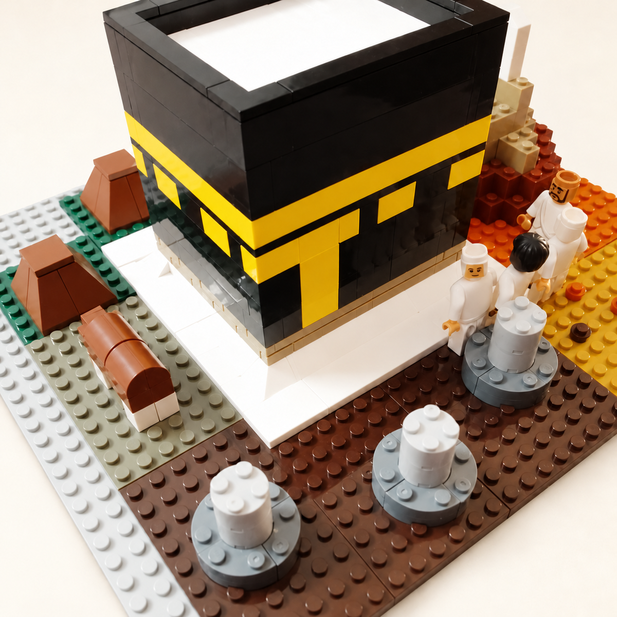 Hajj Blocks Kaabah model and figures on a neutral background