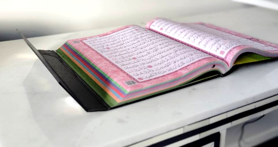 AYFA Quran open with colourful page sections and closing flap