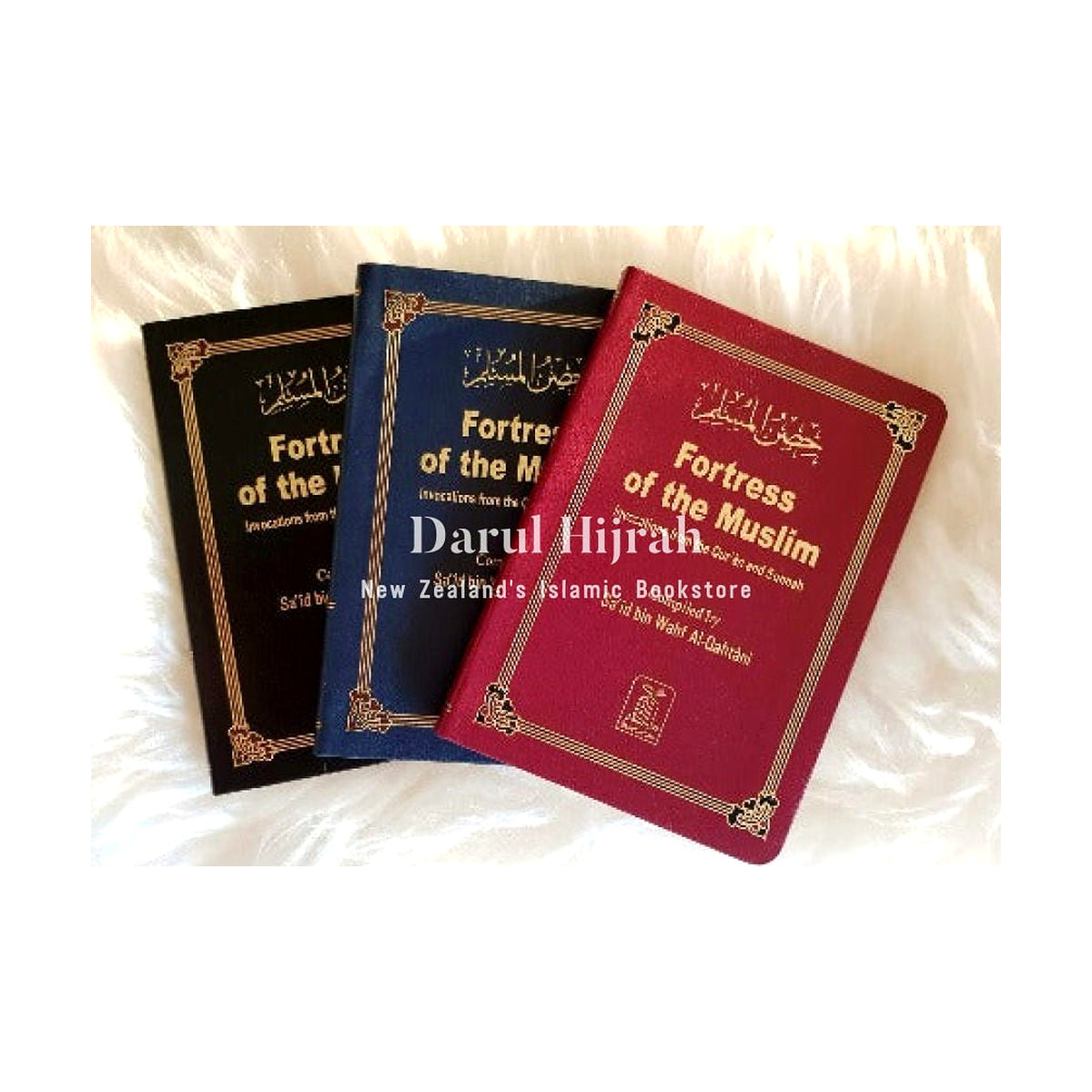 Pocket-size Fortress of the Muslim books in black, blue and red