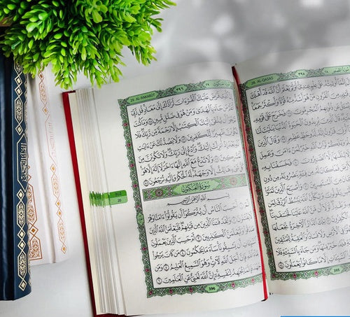 Dakwah Mushaf Madinah inside pages showing Surah Al-Qasas and Al-Ankabut with English surah headings — photo by DeenSquare