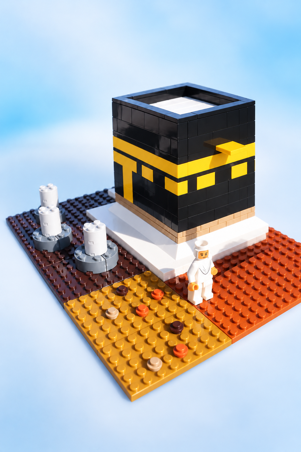Hajj building blocks with Kaabah and surrounding pieces, wider view on a soft blue background