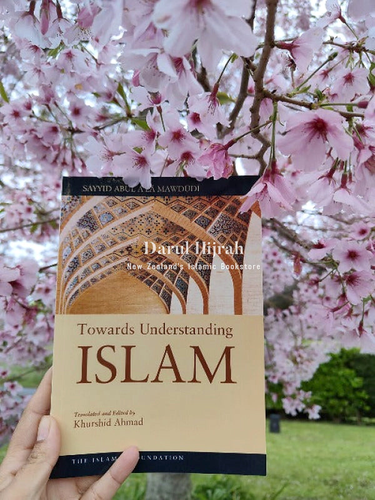 Towards Understanding Islam held beneath pink cherry blossoms